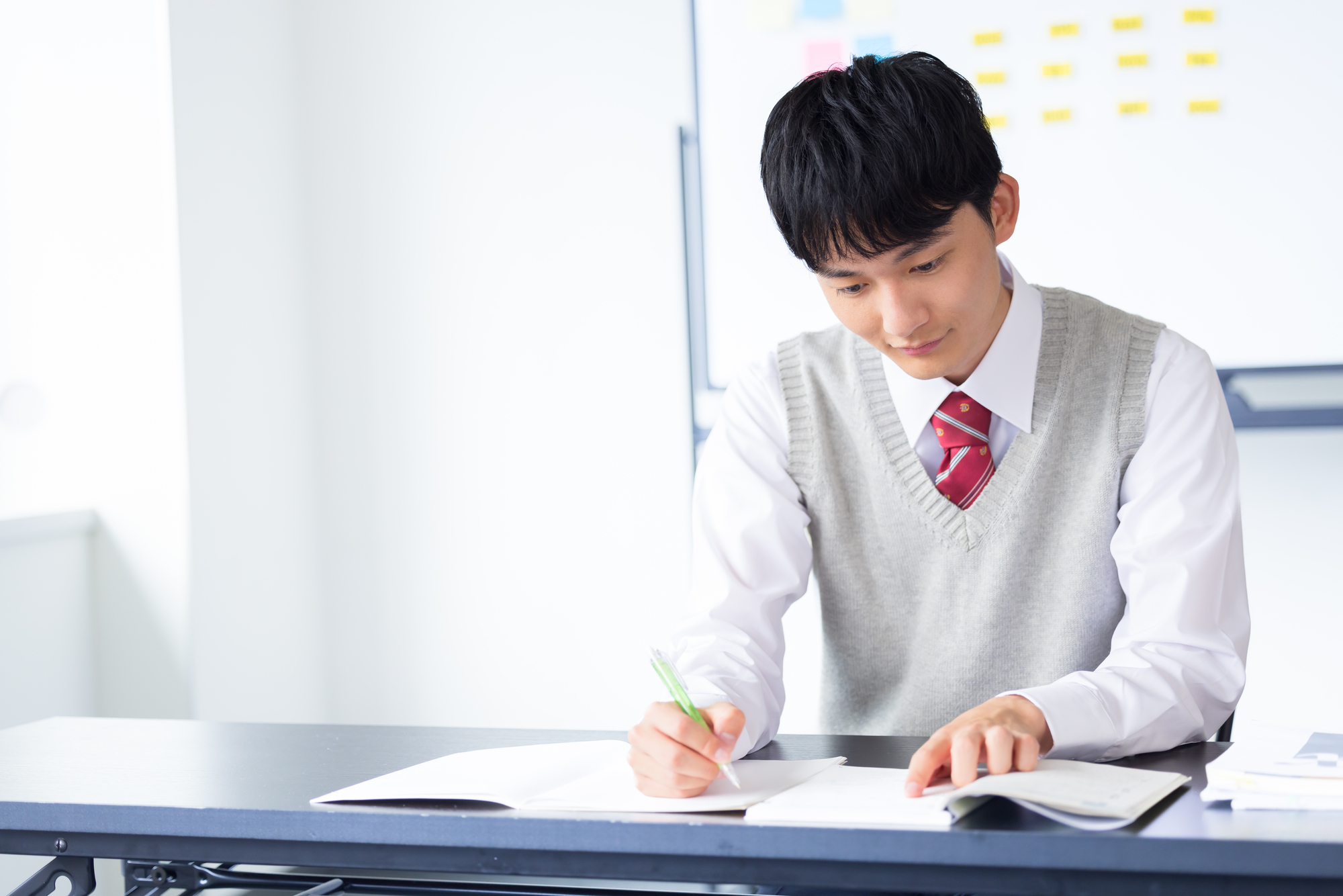 机で複数の教材を確認しながら学習する高校生